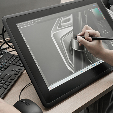 Designer sketching a scooter concept on a graphics tablet