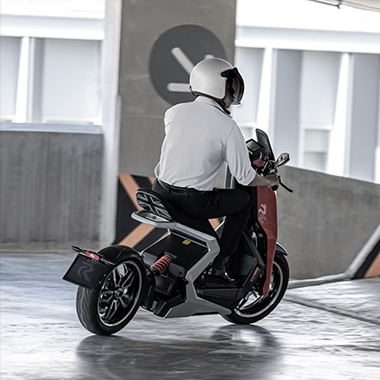 Rider on an R-Series scooter in a parking garage